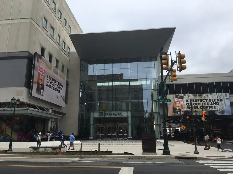 Glass entrance of the Fashion District mall at 9th and Market