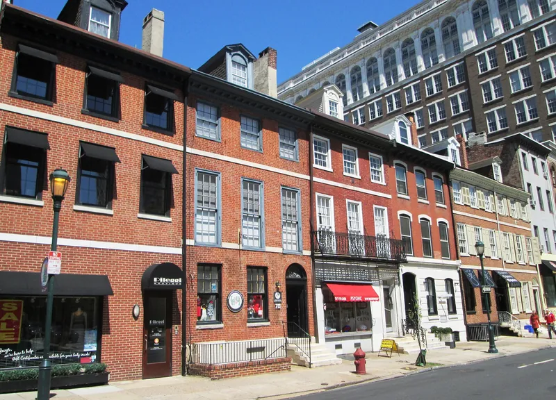 Row of brick shopfront buildings on Walnut Street near 8th